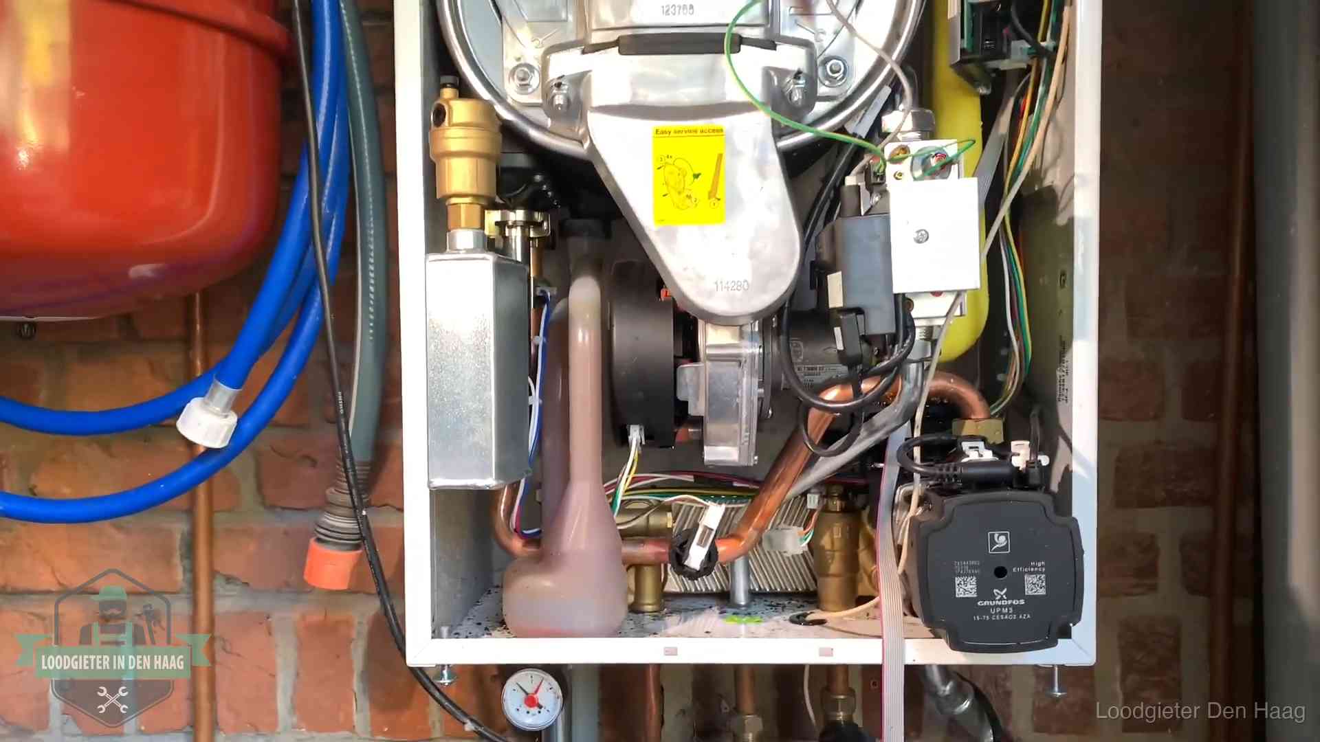 Geopende cv-ketel met rood expansievat in een woning in Den Haag